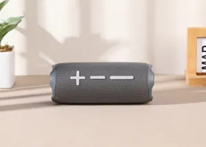 Portable wireless Bluetooth speaker with fabric mesh and big tactile buttons for outdoor music.