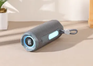 Detailed close-up shot of portable cylindrical Bluetooth speaker with woven fabric mesh and strap.