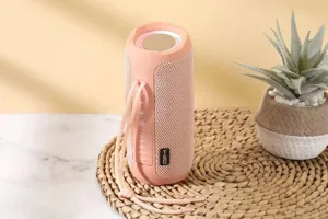 Portable wireless bluetooth speaker with fabric mesh design, pink waterproof subwoofer for outdoors.
