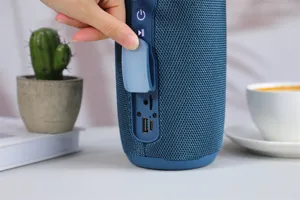 Portable wireless bluetooth speaker with deep bass, fabric mesh and waterproof port cover.