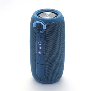 Portable blue bluetooth speaker detail shot, fabric mesh cylinder design with control buttons.