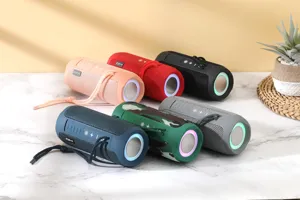 Portable waterproof fabric wireless Bluetooth speaker with colorful lights and deep bass audio.