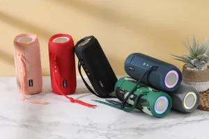 Portable waterproof wireless Bluetooth speaker with fabric mesh and deep bass sound effects.