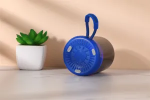 Detail view of the portable blue wireless Bluetooth speaker showcasing its textured base and loop.