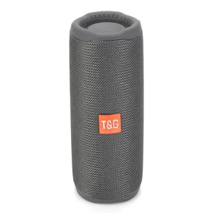 Portable wireless bluetooth speaker close-up view showing grey mesh and orange brand tag.