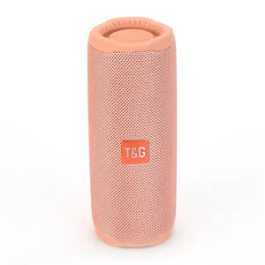 Detail view of the pink portable bluetooth speaker, featuring fabric mesh and clear logo tag.