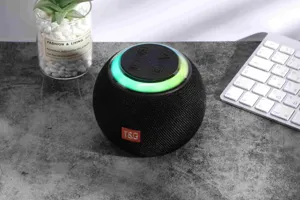 Portable wireless Bluetooth speaker with colorful LED lights, spherical design for desktop.