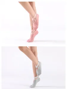 Detail view of non-slip pilates toe socks with cross straps and grip dots for women.