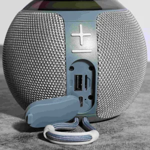 Detail view of portable wireless bluetooth speaker interface, control buttons, and charging port.