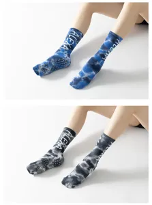Detailed view of tie-dye non-slip yoga socks with grip dots for pilates and dance practice.