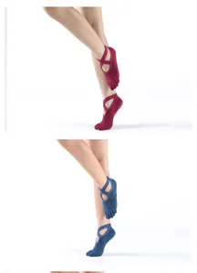 Non-slip yoga socks with cross straps, five-toe design for pilates and fitness workouts.