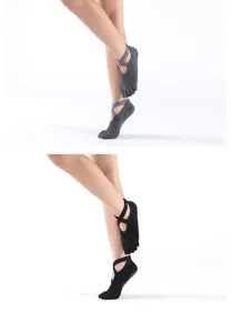 Detail view of non-slip five-toe yoga socks with elastic cross straps for fitness.