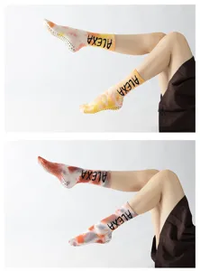 Tie-dye long yoga socks with non-slip grips, stylish pilates and dance footwear detail view.