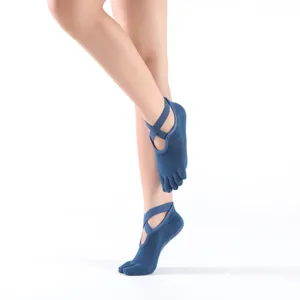Non-slip five-toe yoga socks with cross straps for women pilates fitness and dance practice.