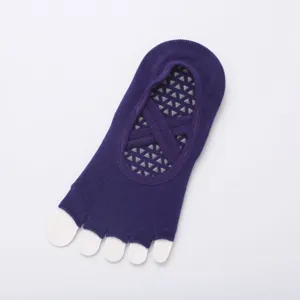 Purple five-toe yoga socks with cross straps and non-slip grips for pilates and fitness.