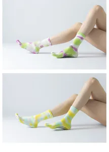 Detailed view of women tie dye yoga five toe socks with non slip grip for pilates workout.