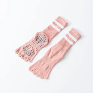 Detailed view of pink five-toe non-slip yoga socks with white double stripes and grip dots.
