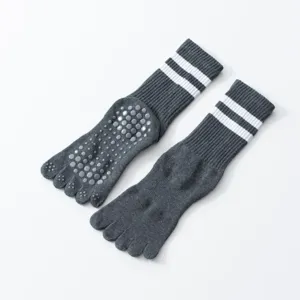 Dark grey five-toe grip yoga socks with white stripes and anti-slip dots for pilates.