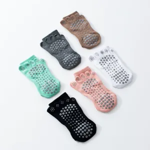 Non-slip five-toe yoga socks detail showing dotted grip and soft cotton blend fabric.