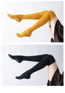 Detail shot of over-the-knee grip socks with anti-slip dots for yoga and pilates.