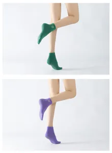 Detail view of breathable yoga socks with anti-slip grip and embroidered XX ankle detail.