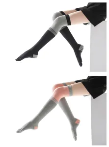 Detail view of over-the-knee five-finger yoga socks with non-slip grips for cozy workouts.
