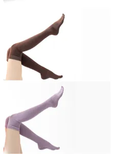 Close-up detail view of over-the-knee five-toe yoga grip socks with anti-slip soles.