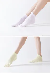 Professional anti-slip yoga five-toe socks with grip details for women training.