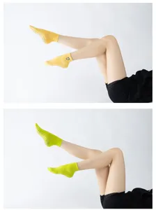 Detail view of women anti-slip yoga pilates socks featuring grip dots and cute embroidery.