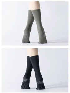 Close-up detail of anti-slip yoga pilates socks with grip dots and ribbed high tube design.