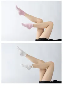 Non-slip yoga socks detail view, showing breathable fabric, grip dots, and ankle embroidery.