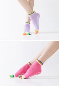 Detailed close-up of women's non-slip yoga five-toe socks with grip dots and colorful cuffs.