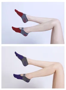 Detail view of five finger yoga socks with anti-slip dots and strap for pilates practice.