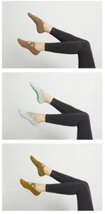 Detalle de calcetines de yoga antideslizantes con rizo grueso y tirantes cruzados de colores.