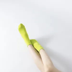 Vibrant neon green women's yoga socks shown in a clean minimalist white background main shot.