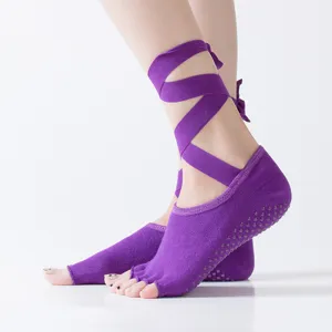 Purple open-toe yoga socks with anti-slip grip and ankle straps for pilates and dance.