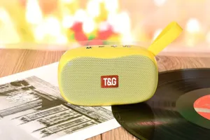 Detailansicht des tragbaren gelben Bluetooth-Laufsprechers mit praktischem Griff auf Holz.