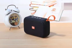 Portable wireless bluetooth speaker with deep bass, TF card slot, and orange strap.