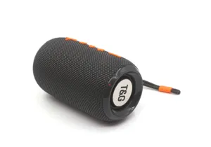 Portable wireless Bluetooth speaker with fabric mesh and orange buttons, detail view.