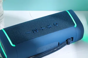 Portable outdoor wireless bluetooth speaker with blue fabric mesh and cool LED ambient lights.