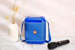Portable blue wireless bluetooth speaker detail view with microphone and strap for outdoor use.