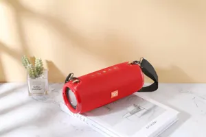 Portable wireless Bluetooth speaker in vibrant red fabric with enhanced bass and strap.