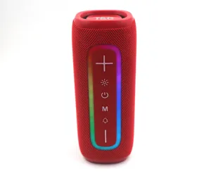 Close-up detail of portable Bluetooth speaker with fabric mesh and RGB ambient lighting.