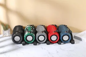 Portable wireless bluetooth speaker with dual diaphragms, fabric mesh, colorful options.