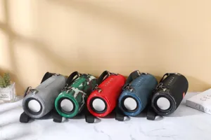 Detailed view of portable fabric bluetooth speakers in multiple colors, outdoor design.