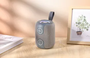 Vue rapprochée d'enceinte Bluetooth sans fil portable, design cylindrique avec sangle.