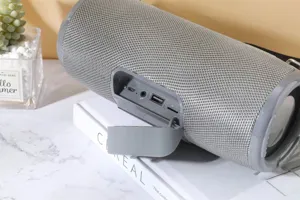 Portable wireless Bluetooth speaker with waterproof fabric design and rich bass sound for outdoor.