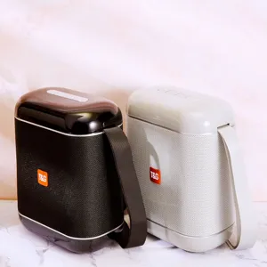 Portable outdoor Bluetooth speaker with TWS function, handheld strap, and powerful bass.