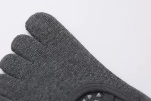 Close-up detail shot of dark grey five-toe yoga socks featuring anti-slip grip particles.