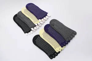 Detail view of non-slip five-toe yoga socks with silicone grip dots and toe separation design.